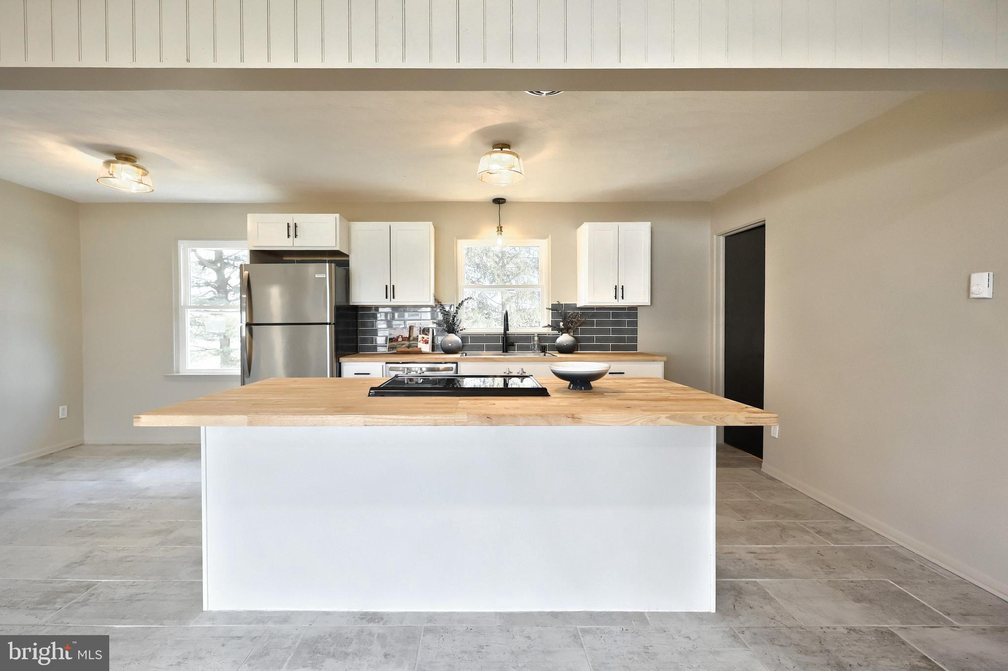 880 Springvale Road Red Lion, PA 17356 - Photo 15 of 39 a kitchen with kitchen island a sink a stove a refrigerator and cabinets