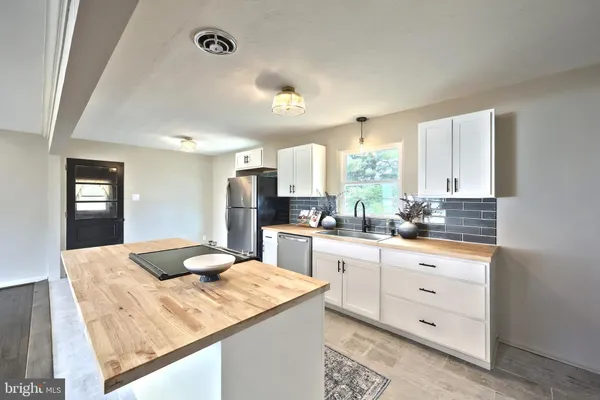 a kitchen with a sink appliances and cabinets