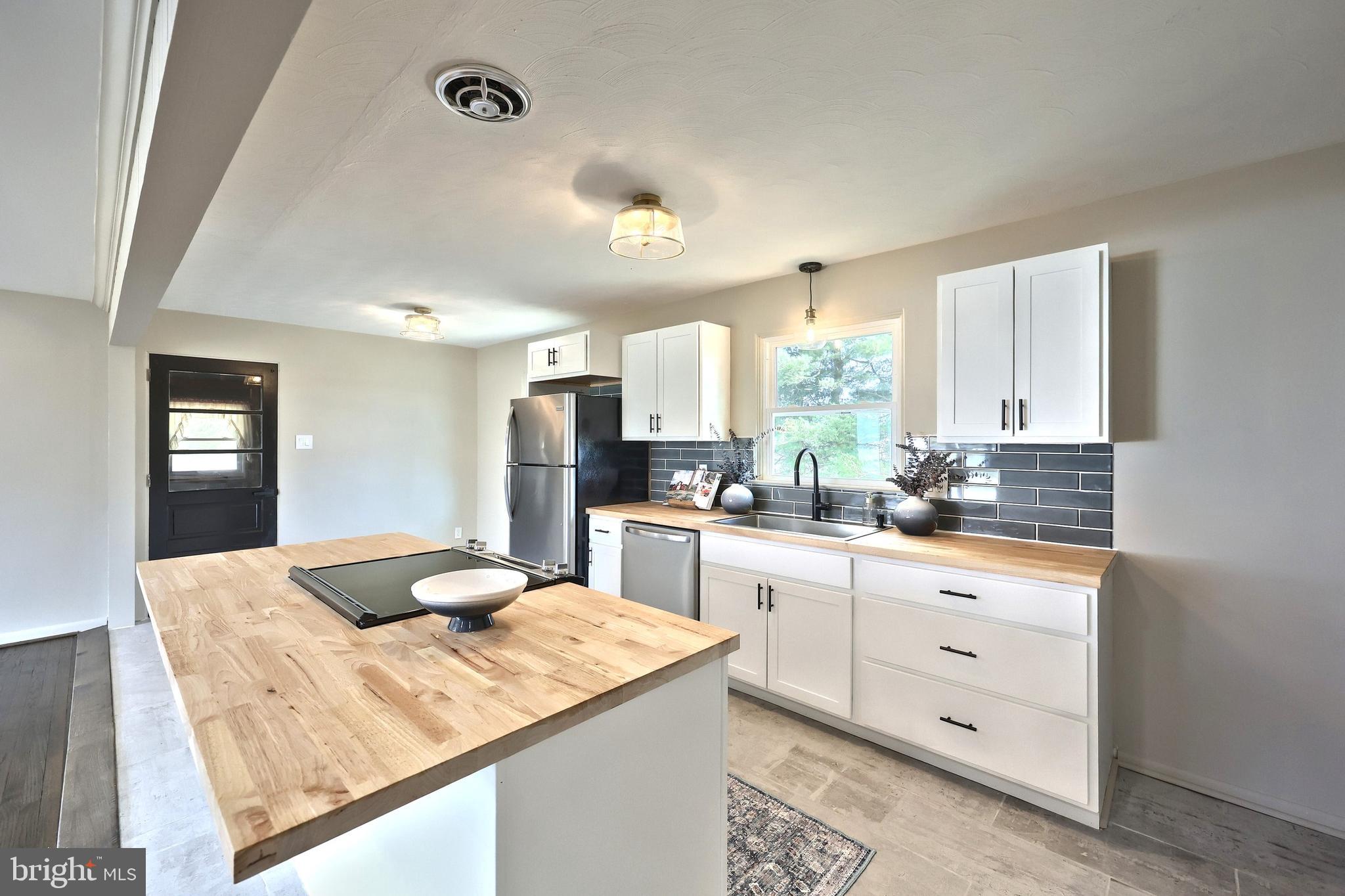 880 Springvale Road Red Lion, PA 17356 - Photo 17 of 39 a kitchen with granite countertop cabinets stainless steel appliances a sink and a window