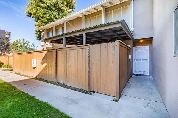 a view of a house with a wooden fence