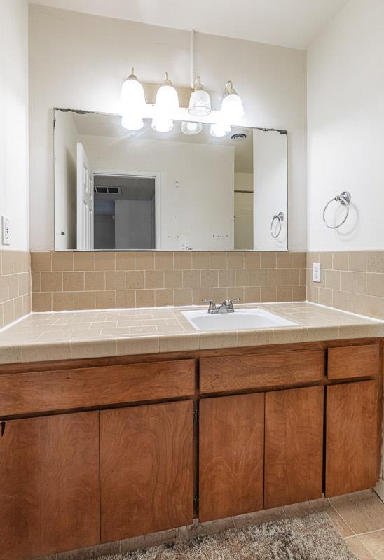 6646 North 3rd Street Fresno, CA 93710 - Photo 11 of 19 a bathroom with a sink and a mirror