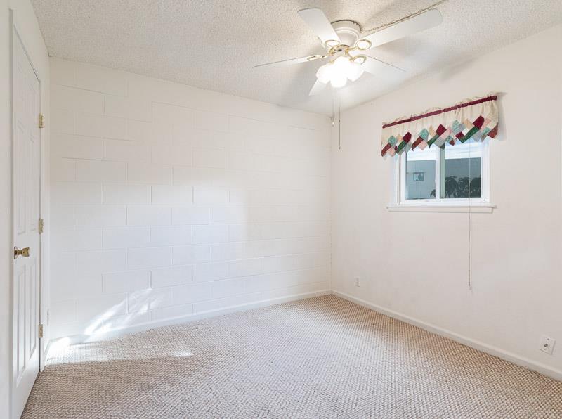 6646 North 3rd Street Fresno, CA 93710 - Photo 13 of 19 an empty room with windows and fan