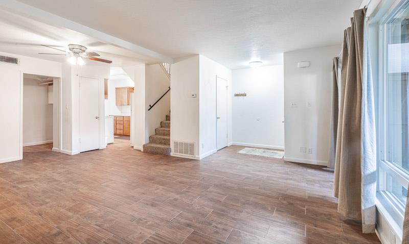 6646 North 3rd Street Fresno, CA 93710 - Photo 3 of 19 an empty room with wooden floor and windows