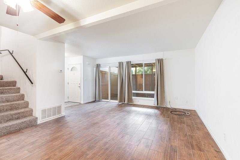 6646 North 3rd Street Fresno, CA 93710 - Photo 4 of 19 a view of an empty room with wooden floor and a window