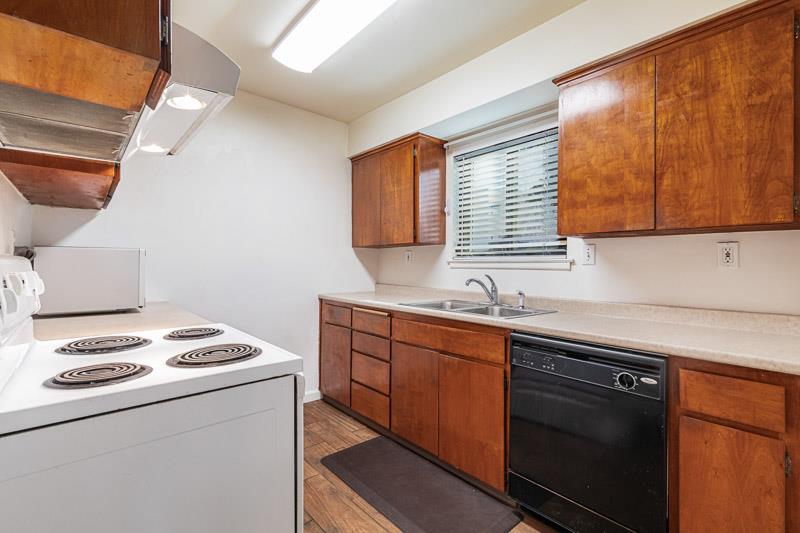 6646 North 3rd Street Fresno, CA 93710 - Photo 5 of 19 a kitchen with granite countertop cabinets sink stove and microwave