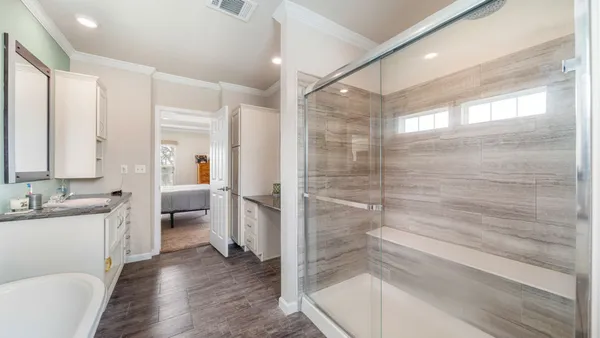 a bedroom with a bed and a flat screen tv on dresser