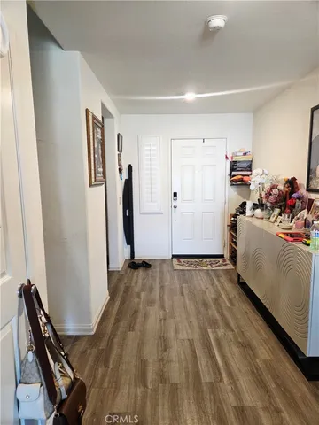 a view of a room with workspace and wooden floor