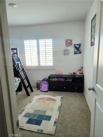 a bed room with a bed and a window