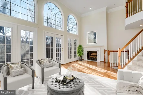 a living room with furniture a fireplace and a large window
