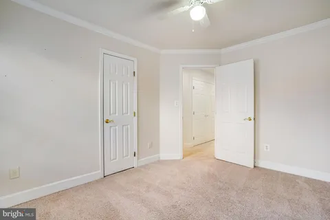 an empty room with a ceiling fan