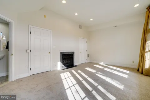 a view of empty room with a fireplace