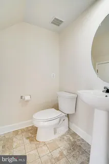 a bathroom with a toilet and a sink