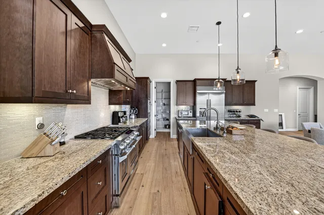 a kitchen with sink stove and cabinets