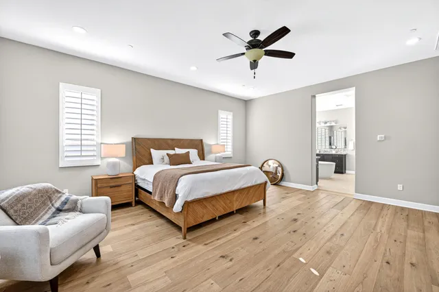 a bedroom with a bed and wooden floor