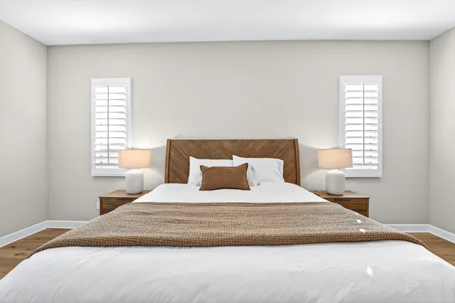 a bedroom with a large bed and a window