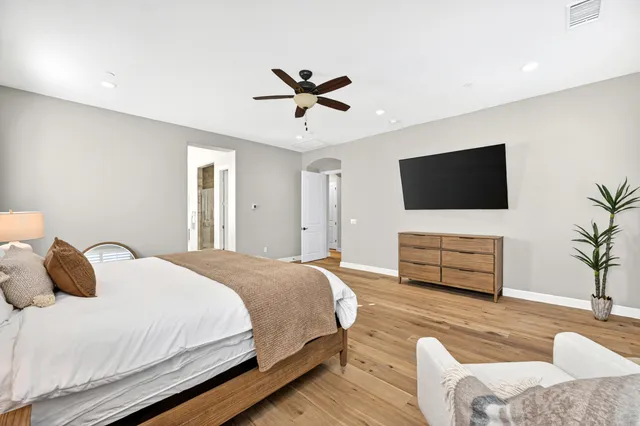 a bedroom with a bed and a flat screen tv