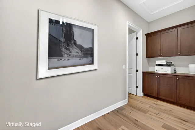 a view of a kitchen with wooden floor and a refrigerator