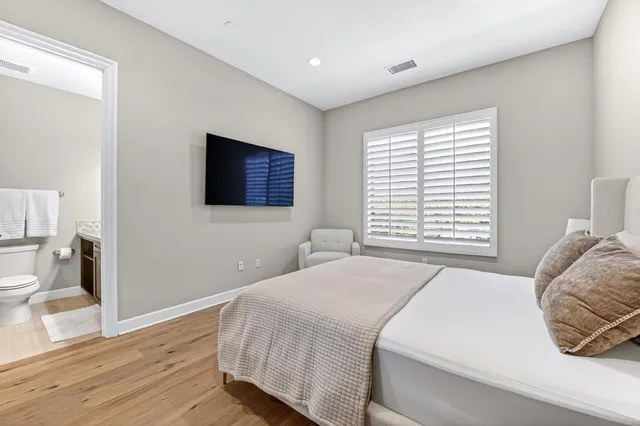 a bedroom with a bed and a flat screen tv