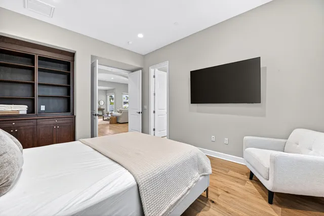 a bedroom with a bed and a flat screen tv