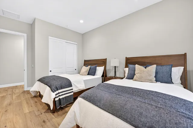 a bedroom with two beds and a lamp