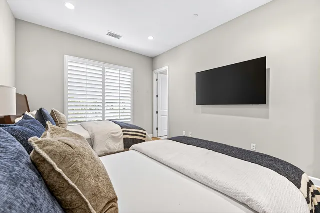 a bed room with two bed and a flat screen tv