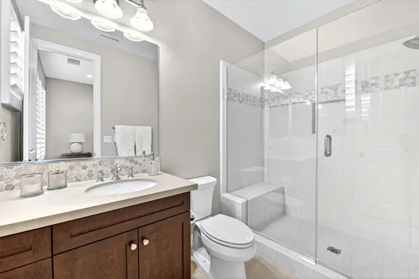 a bathroom with a sink toilet and shower