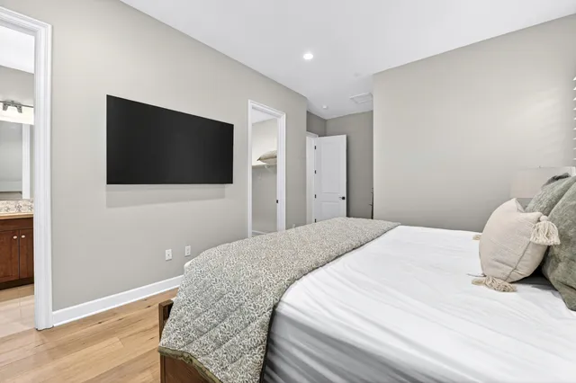 a bedroom with a bed and a flat screen tv