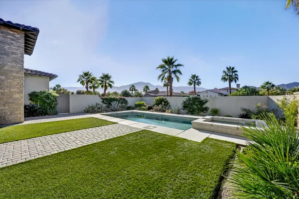 a view of swimming pool with outdoor seating and plants