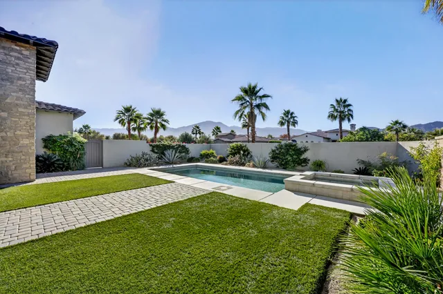 a view of swimming pool with outdoor seating and plants