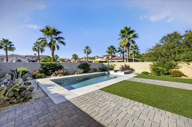 a view of swimming pool with outdoor seating and a yard