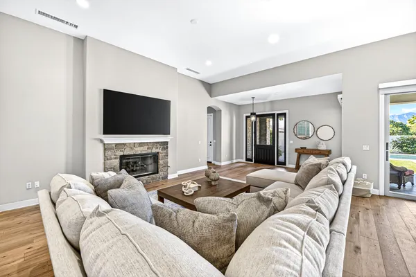a living room with furniture a fireplace and a flat screen tv