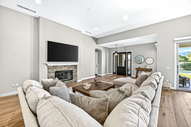 a living room with furniture a fireplace and a flat screen tv