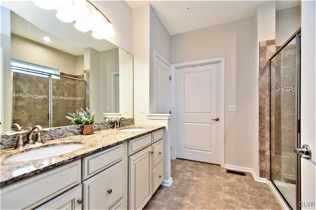 2497 Raya Way Easton, PA 18045 - Photo 16 of 39 Master bath with tile floor, double vanity, and ti