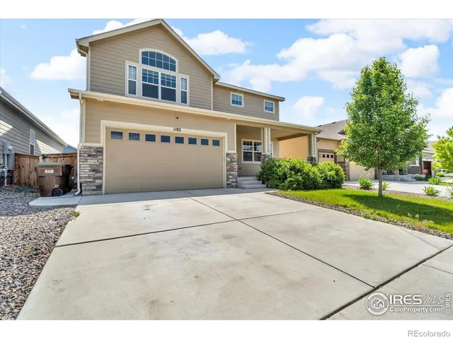 a front view of a house with a garden and pathway