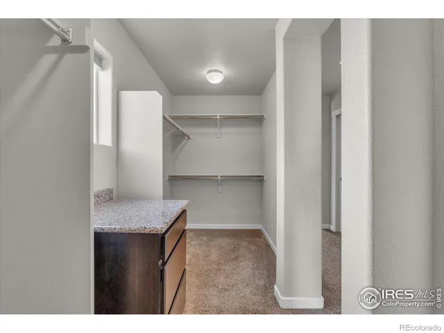 a kitchen with cabinets and a refrigerator