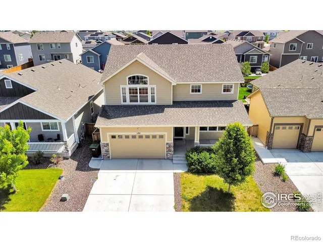 a aerial view of a house with a yard and potted plants