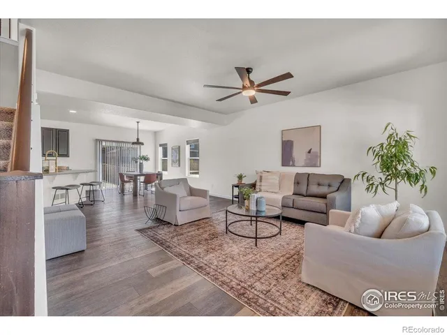 a living room with furniture and a view of kitchen