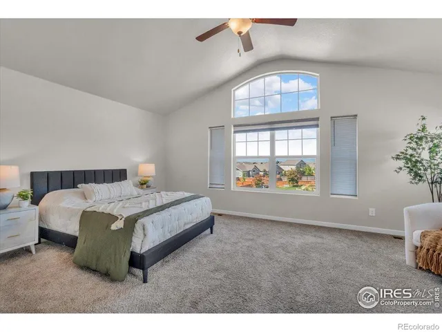 a spacious bedroom with a bed and a window