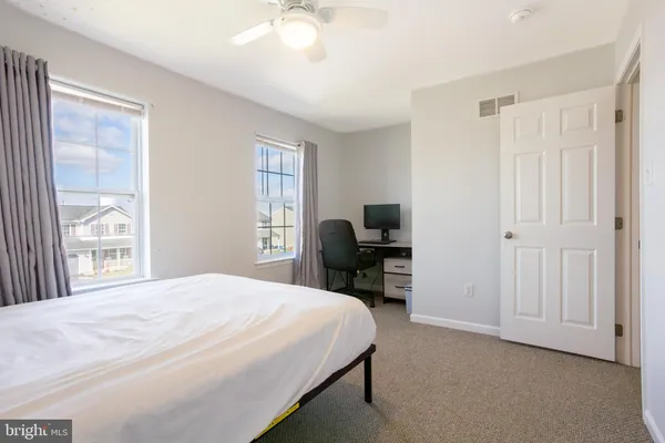 a bedroom with a bed and a chair