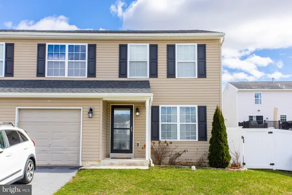 a car parked in front of a brick house