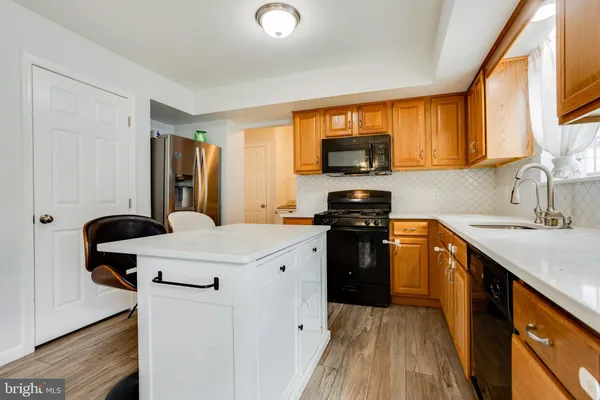 a kitchen with a stove a sink and a microwave