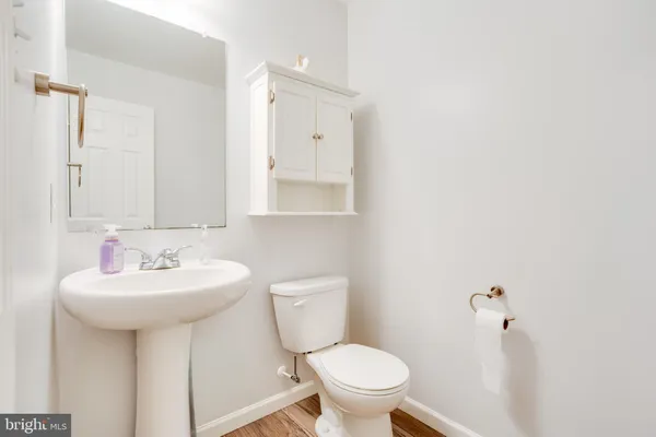 a bathroom with a sink mirror toilet and vanity