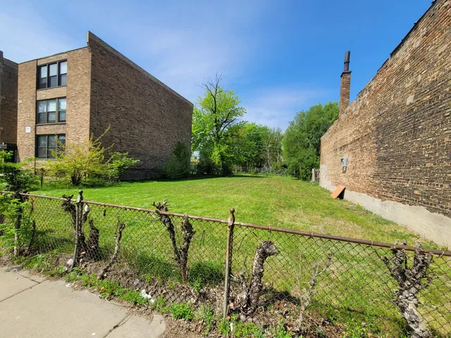 a view of a garden with a building in the background