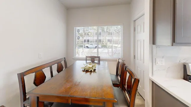 a view of a dining room with furniture window and outside view