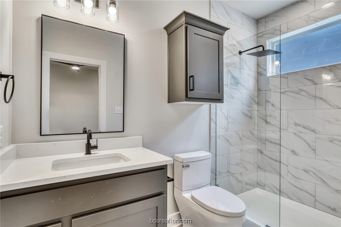 301 Cooner Street, Unit B College Station, TX 77840 - Photo 14 of 36 a bathroom with a sink a toilet and shower