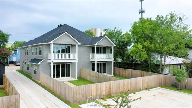 a front view of a house with wooden fence