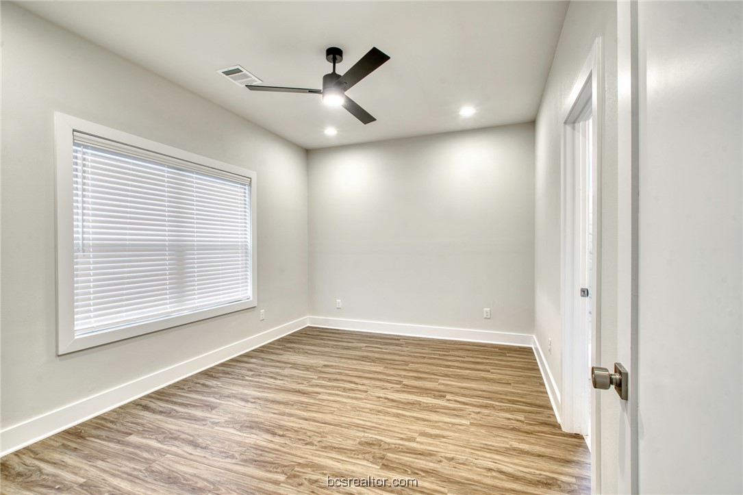 301 Cooner Street, Unit B College Station, TX 77840 - Photo 20 of 36 a view of an empty room with wooden floor and a window