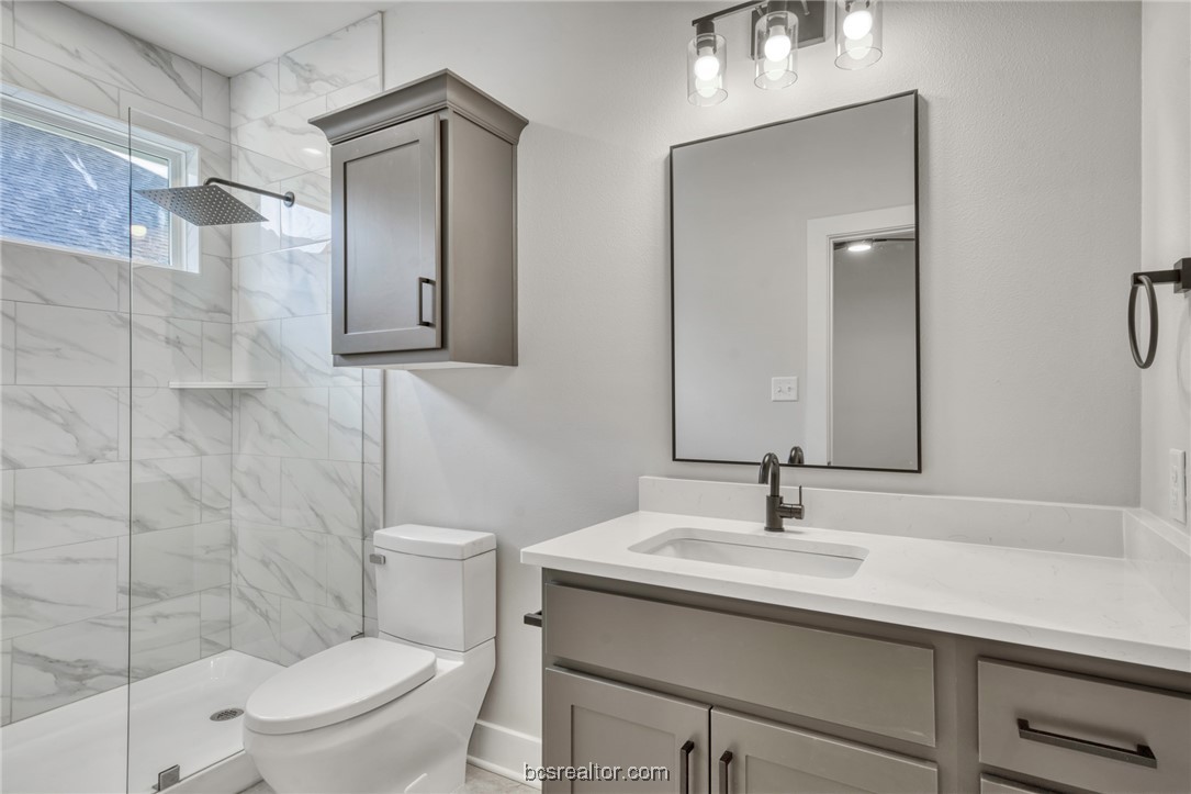 301 Cooner Street, Unit B College Station, TX 77840 - Photo 23 of 36 a bathroom with a sink toilet and shower