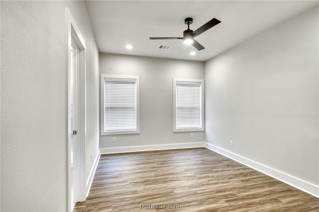 301 Cooner Street, Unit B College Station, TX 77840 - Photo 25 of 36 wooden floor in an empty room with a window