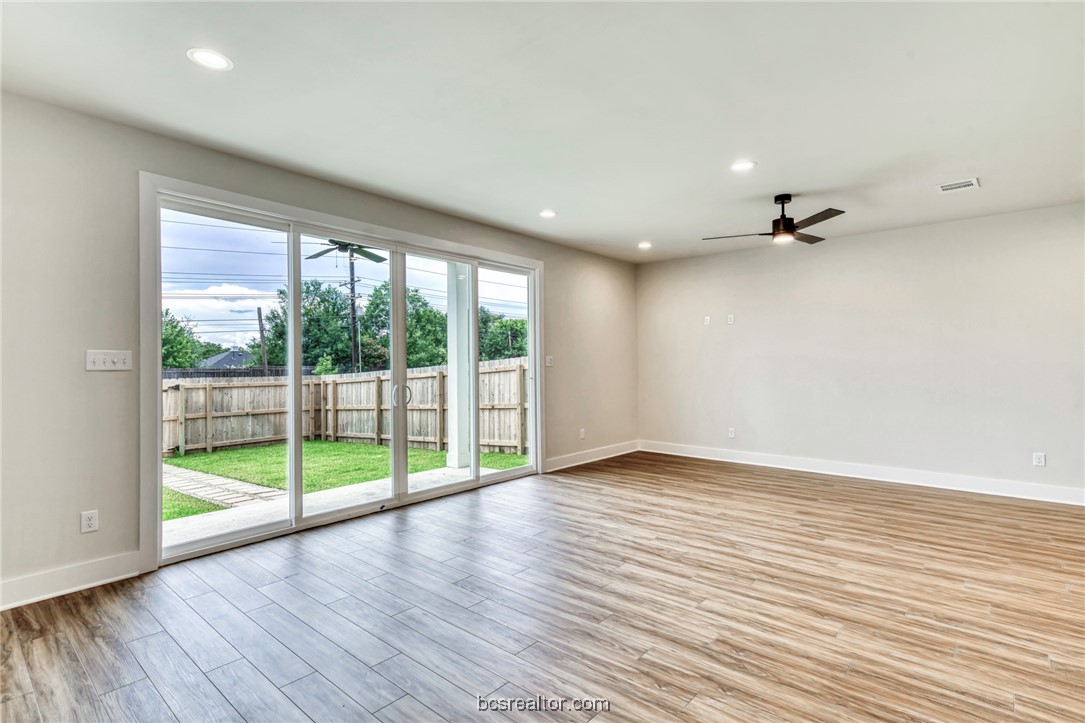 301 Cooner Street, Unit B College Station, TX 77840 - Photo 6 of 36 wooden floor in an empty room with a window